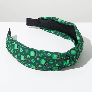 Detail showing the green shamrock print and knotted fabric of the St. Patrick's Day headband
