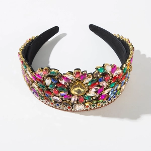 Detailed macro view of colorful multi-shape rhinestones on a black velvet crown headband