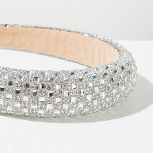 Close-up of sparkling silver square rhinestones and soft velvet lining on a padded headband