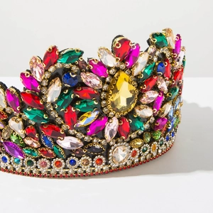 Close-up detail of luxurious gold crown with colorful marquise crystals for weddings