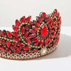 Macro side view of baroque crown with sparkling red marquise gems and silver rhinestones