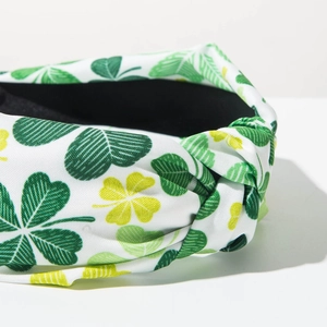 Detail of St. Patrick's Day wide headband with green shamrock pattern and twist knot