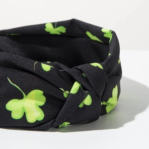 Detail showing the green clover print fabric and knotted design on St. Patrick's Day headband