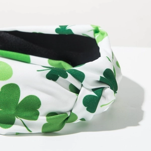 Detail of St. Patrick's Day headband with green shamrock pattern and top knot texture