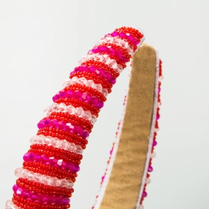 Détail de serre-tête fait main avec perles en cristal rayées rose et rouge