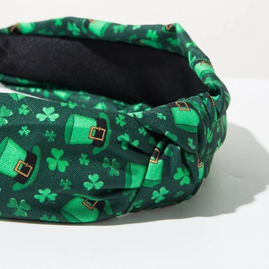 Close-up of Saint Patrick's Day knotted headband featuring green clover and hat patterns