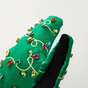 Detail of green Saint Patrick's Day knotted headband with colorful rhinestone embroidery