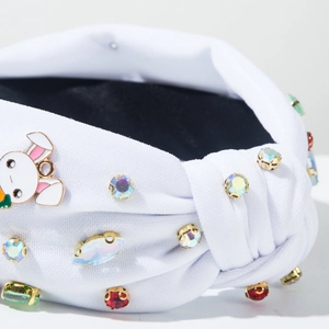 Macro shot of white knotted headband with colorful rhinestones and cute bunny detail