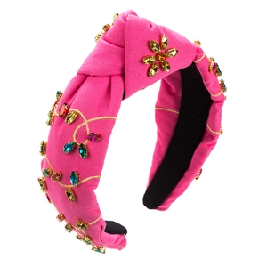 Detail of hot pink knotted headband with colorful rhinestone floral vine patterns