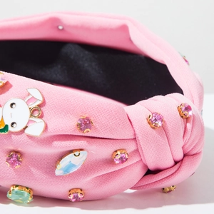 Close-up of pink Easter headband featuring rhinestone embellishments and cute bunny charm