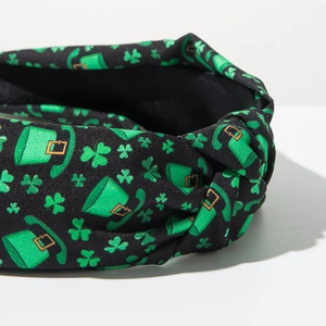 Detail shot of St. Patrick's Day knotted headband with green clover and hat patterns