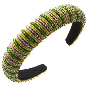 Détail d'un serre-tête coloré orné de perles de cristal vertes dorées et violettes