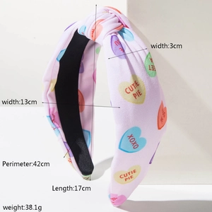 Pink fabric knot headband with heart prints and size specs of 17cm length and 38g weight