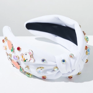 Close-up of white knotted headband with rhinestone rabbit and carrot charms