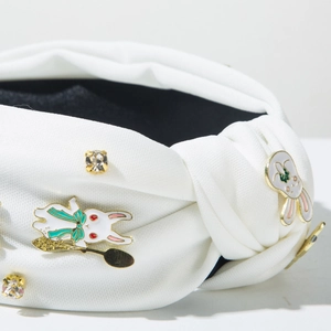 Détail d'un serre-tête blanc à nœud avec strass et charms lapins mignons en émail