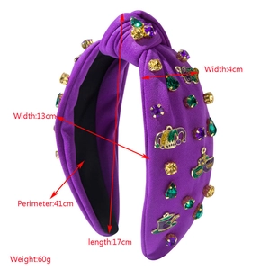 Mardi Gras themed knot headband with purple fabric, colorful faux gems and festive charms