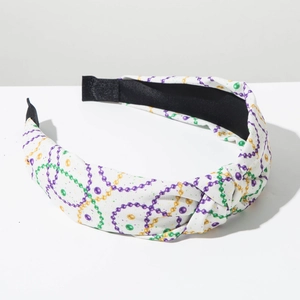 Detalle de una diadema de nudo Mardi Gras con estampados de cadenas moradas y verdes