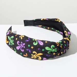 Detalle de la diadema con nudo de Mardi Gras con patrones de flor de lis morados y verdes