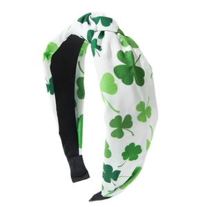 Green shamrock knotted headband for St. Patrick's Day party on white background