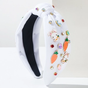 Detailed view of Easter headband featuring rhinestone rabbit and carrot charms on white fabric