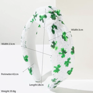 Detail view of St. Patrick's Day headband with green sequin shamrocks and white fabric