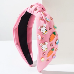 Detail of pink knitted Easter headband with rhinestones, bunny and carrot charms