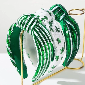 Detail of St. Patrick's Day sequin headbands with shamrock and green white stripe patterns