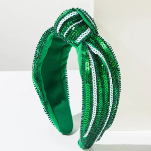 Close-up of green and white sequined knotted headband with sparkling vintage details