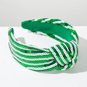 Detail of St. Patrick's Day headband with green and white striped sequins and a top knot