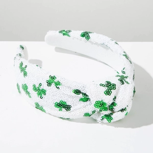 Close-up of St. Patrick's Day headband with white sequins and green shamrock patterns