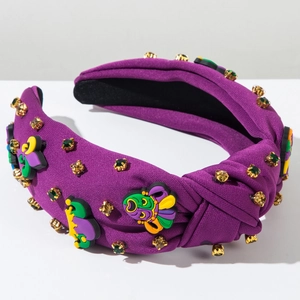 Détail de serre-tête violet noué avec masques de Mardi Gras et strass multicolores