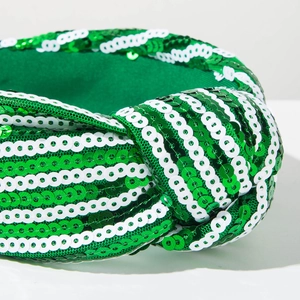 Detail shot of the St. Patrick's Day knotted headband with green and white sequins