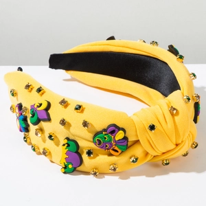 Détail du bandeau jaune torsadé avec masques de carnaval et strass scintillants