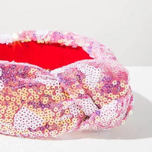 Detailed macro view of sequin headband with soft red velvet lining for comfort