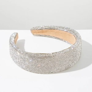 Close-up of sparkling silver rhinestones on wide padded headband with soft velvet lining