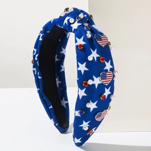 Detail of knotted USA flag headband with white pearls and heart shaped flag emblem
