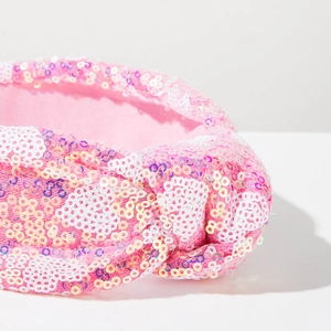 Detailed close-up of pink and white sequin knotted headband with premium soft fabric lining