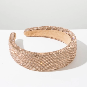 Close-up of luxury wide padded headband with sparkling champagne rhinestones and soft lining