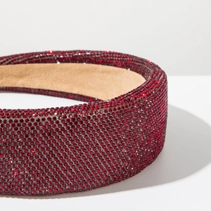 Detail shot of the red rhinestone padded headband with a non-slip velvet inner lining