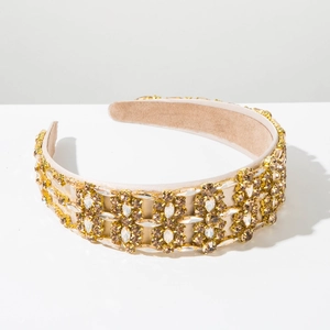 Detailed macro view of Baroque style wide headband with sparkling champagne rhinestones