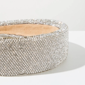 Close-up of luxury wide headband with shimmering silver micro-rhestones and soft lining