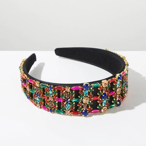 Detailed close-up of Baroque velvet headband with multi-colored rhinestones in gold claw settings