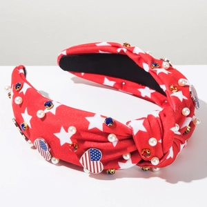 Detail of red knotted headband with American flag stars, pearls, and colorful gemstones