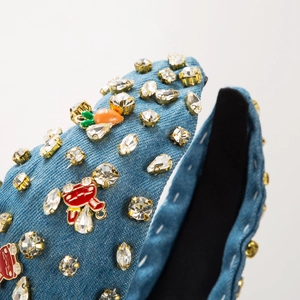 Detail of blue denim headband with sparkling rhinestones and carrot alloy ornaments