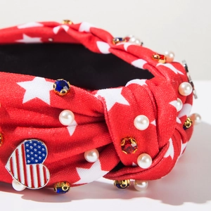 Close-up of knot headband with American flag heart, white pearls and sparkling rhinestones
