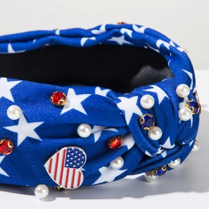 Close-up of knotted headband featuring American flag heart, white stars and faux pearls