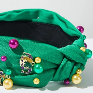 Detail of green carnival headband with colorful pearls and glitter crown accessory