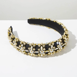 Close-up of luxury sponge headband with sparkling rhinestones and white flowers