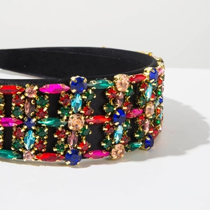 Close-up of Baroque padded headband with colorful rhinestones and gold metal claw settings