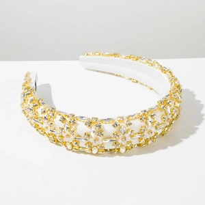 Close-up of sparkling crystals and floral rhinestones on wide satin sponge headband